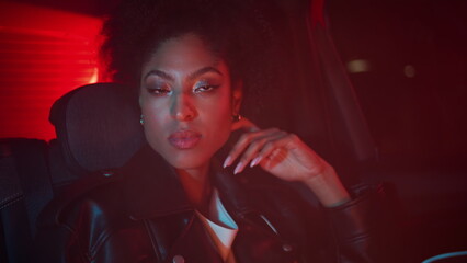 Gorgeous lady sitting car looking pensive closeup. African woman relaxing