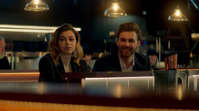 Beautiful Caucasian couple having a date in a stylish restaurant, talking and laughing. Shot with 2x anamorphic lens