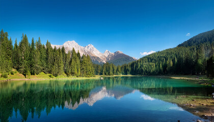 Fototapeta premium serene mountain lake surrounded by pine trees rocky cliffs and clear blue sky reflecting natural beauty and calmness