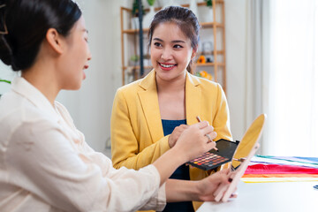 Young Asian woman doing personal color diagnosis for determining skin undertone and seasonal color...