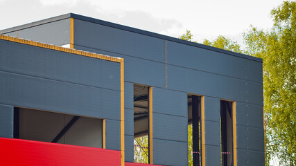 new grey building with red stripe during construction