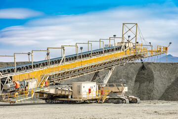 At a copper mine, a mobile conveyor system steadily builds a leaching pile, crucial for mineral recovery.