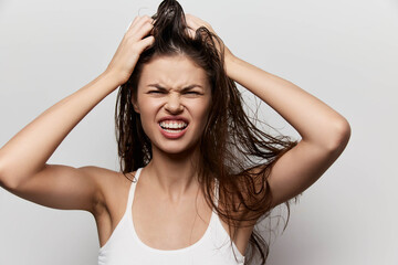 frustrated woman with messy hair, showing emotions, holding her head, expressing stress and...