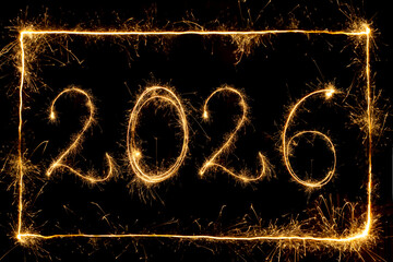 Happy New Year 2026. Number 2026 written sparkling sparklers on rectangular frame and black background  . Glowing, creative overlay template for holiday greeting card or banner design