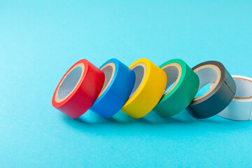 Insulating tape on a bright colored background. Set of different colors insulating tape. Reel...
