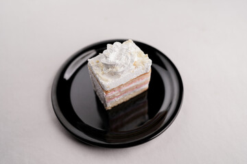 Delicious white forest cake slice on black plate