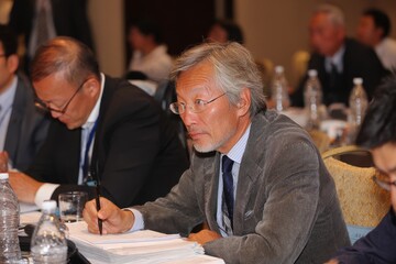 Asian boardroom discussion centered on recycling, waste management, and creating eco-conscious corporate culture