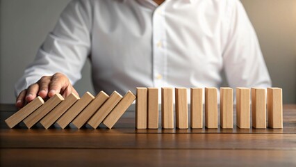 Hand stopping falling wooden blocks image