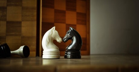 Chess pieces, vintage black and white knight, dark gray background. Chess sports, business games, power, leadership concept	