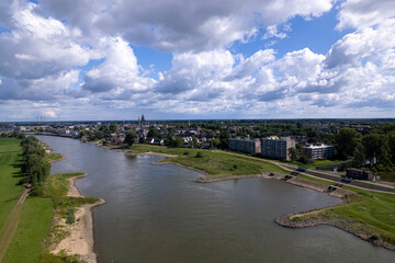 Dutch landscape with river IJssel inland shipping strong current waterway on a sunny day