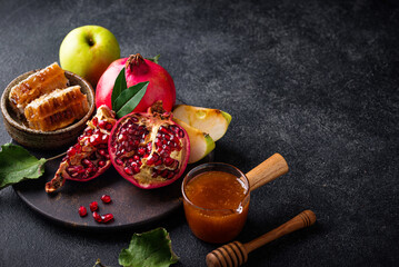 Rosh Hashana concept with honey, apple and pomegranate