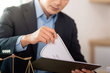 Legal Consultation. Lawyer reviewing important documents in office.