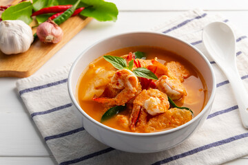 Red curry Pineapple and shrimp in white bowl.(Kang Kua Subpharod Kung) Thai food.