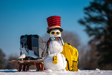 Snowman traveler with suitcase. Winter adventure with snow man. Funny snowman tourist. Christmas...