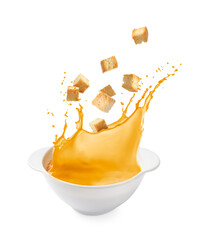 Croutons falling into bowl of soup against white background