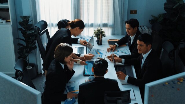 Top view of diverse business people brainstorm marketing idea while marketing team analyst stock market investment. Group of skilled project manager solving problems and sharing plan. Directorate. - Powered by Adobe