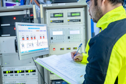 Electrical engineer woman checking voltage at the Power Distribution Cabinet in the control room,preventive maintenance Yearly,Thailand Electrician working at company