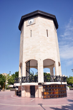 Stunning clock tower in a sunlit plaza, ideal for travel, architecture, and tourism projects