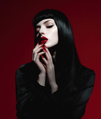 Fashion model with red lipstick and long nails, gothic style