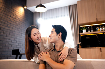 Happy couple, couch and hug in home with love, marriage and romance for man and woman in living room. Sofa, smile or support for relationship, relax or trust for commitment and embrace.