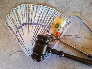 Judge's gavel, money and stethoscope