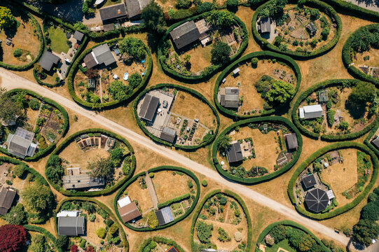 Aerial view of the round gardens, a whimsical landscape of neatly manicured circular plots, each a tiny world of verdant hedges and miniature dwellings, NÃ¦rum, Denmark.