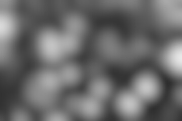 Abstract monochrome background with soft blurred spots, creating a sense of depth and mystery with