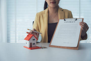 Real Estate Contract Presentation: A poised real estate agent presents a home contract alongside a...