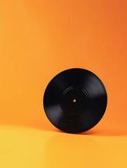 Black vinyl record on vibrant orange background. Retro music banner with copy space for creative design