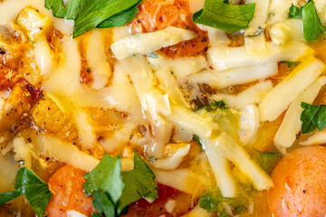 Background with the texture of an omelet with vegetables, sausages, cheese and parsley. Close-up, top view