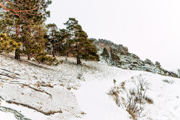 Landscape of Siberia mountains Stolbi, rock peak Takmak range in haze winter