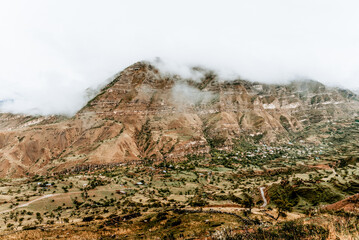 Landscape of Dagestan mountains, mountain range in haze summer Russia