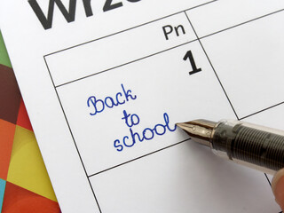 handwritten text Back to school Due Date In Calendar. Close up of Back to school written on date...