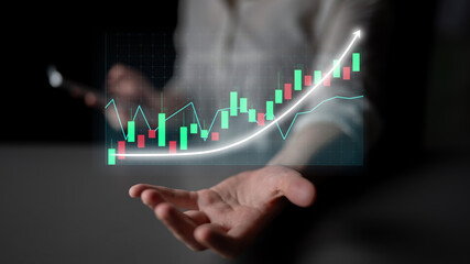 A businessman showcases a futuristic stock market graph with an increasing trend on his palm,...