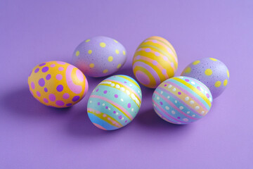 Fototapeta premium Pastel Easter eggs on purple background festive spring decoration