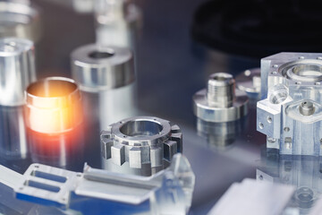 Precision metal components on reflective surface after cnc machining