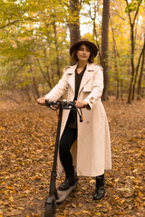 Woman enjoying a scooter ride among yellow trees on a crisp fall day