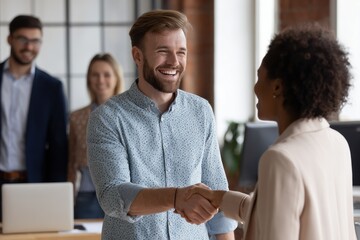 Corporate scene showing cheerful manager greeting new team member with handshake, full view in clean office, welcoming and collaborative atmosphere