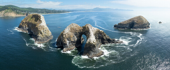 Rugged sea stacks rise from the Pacific Ocean off the coast of northern Oregon. Impressive sea...