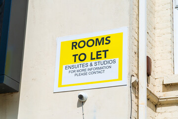 Rooms to let sign - property rental, student accommodation sign on the side of a building