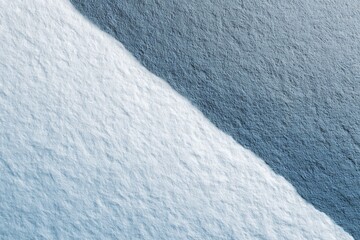 A textured paper background with a diagonal split between white and blue, creating an abstract and artistic design element.