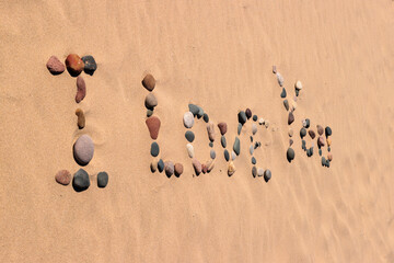 Looking horizontally at rocks placed carefully on the beach to provide the message "I Love You" at Kohler-Andrae State Park, Sheboygan, Wisconsin