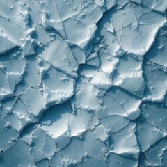 Aerial view of broken ice floes with cracks and shadows on a cold surface