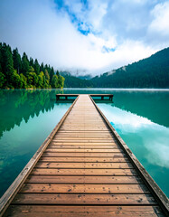 pier to the lake and mountain background