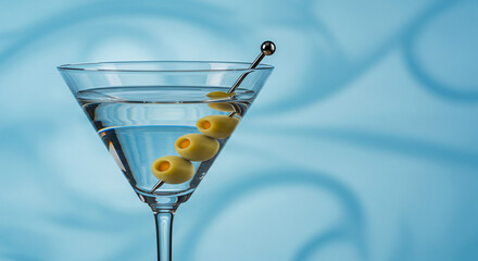 Classic Martini Cocktail with Olives on Blue Background - High-quality stock image for commercial use