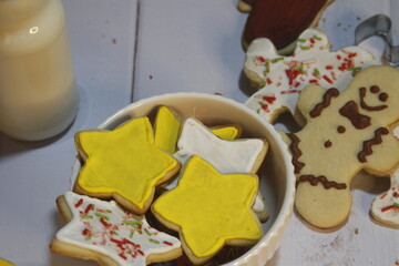 Festive gingerbread cookies shaped like stars, arranged in a cozy bowl, perfect for holiday...
