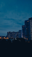 Fototapeta premium Dusk falls over Soviet-style Kyiv highrise buildings in a silent sleeping area