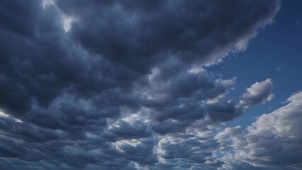 Rolling storm clouds stretch across vast sky conveying change movement tension natural transformation awakening themes of uncertainty adaptation and anticipation in the environment