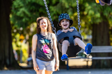 Joyful Toddler Playing on Swing in a Park in Burnaby, BC, Canada