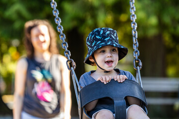 Young Boy Enjoying Swinging Outdoors in Burnaby, Vancouver, BC, Canada